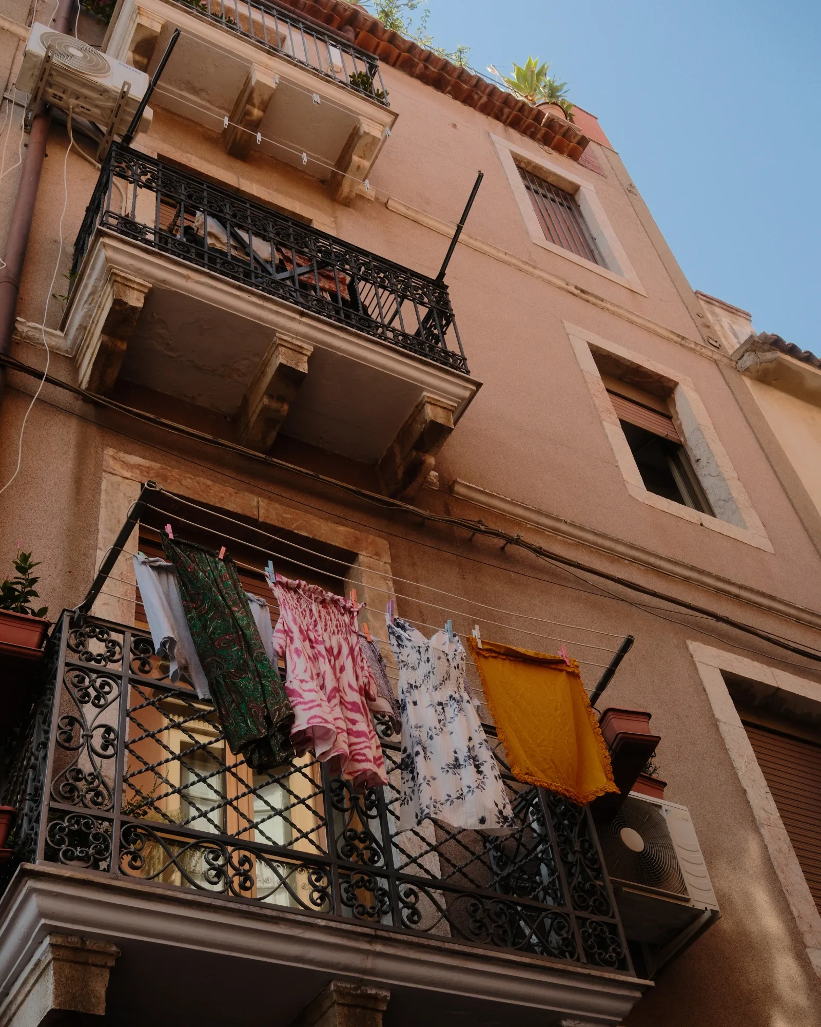 Clothes are drying on the balcony of a street in Taomina, Sicily - Essenza Fujifilm Film recipe