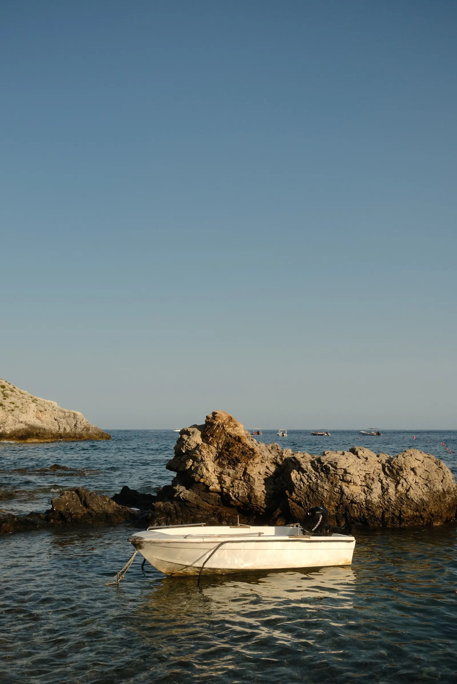 A small boat in Isola Bella, Taormina, Sicily - Essenza Fujifilm Film recipe