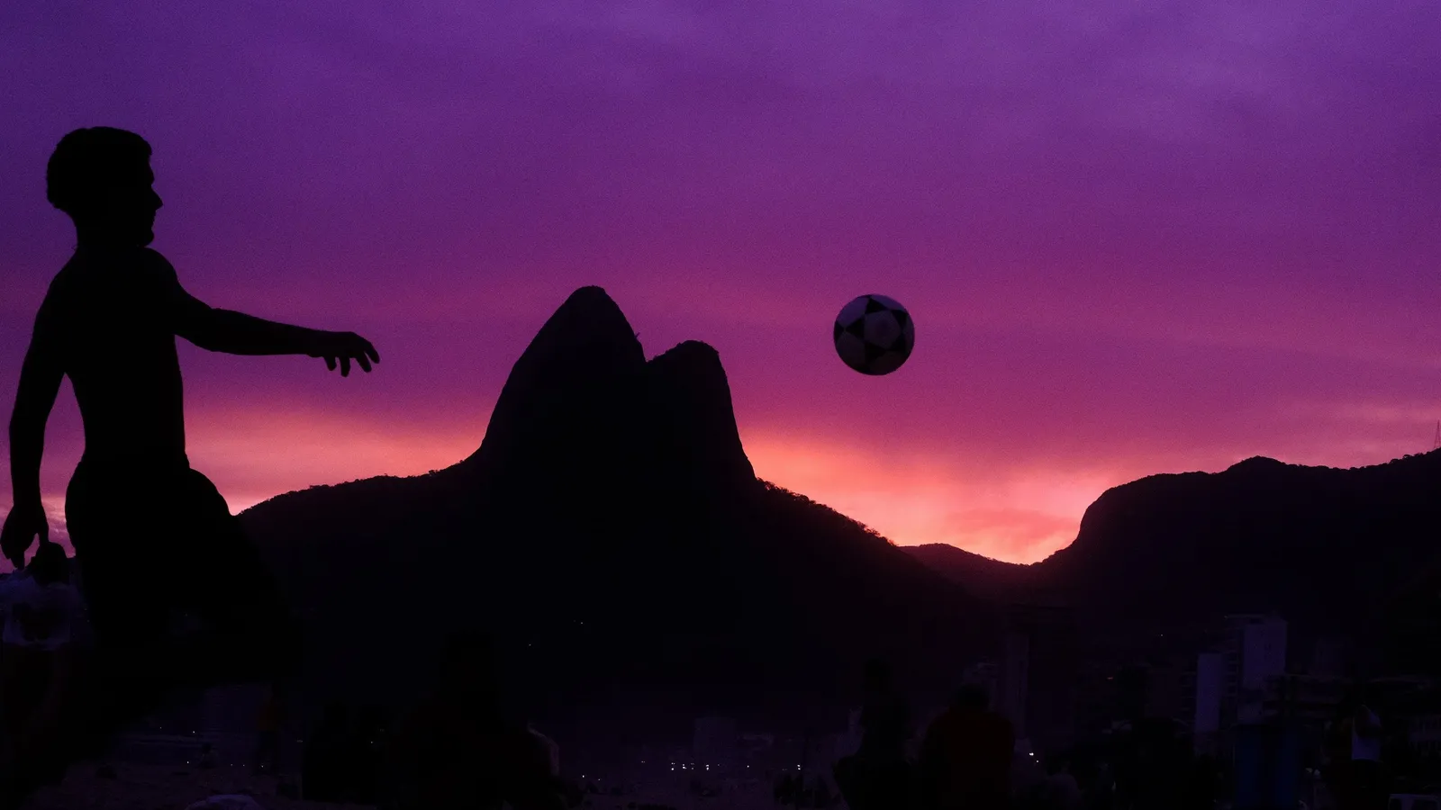 Silhouette heading a football against a purple and pink twilight sky over Rio, the Velvet Dreams recipe on Velvia
